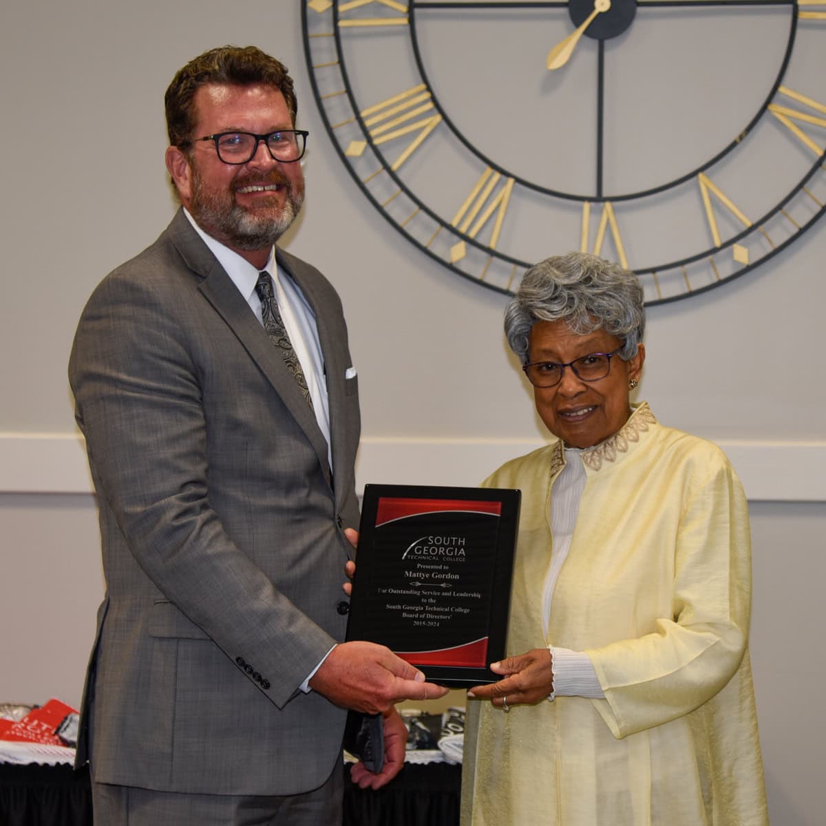 SGTC President Dr. John Watford (left) is shown above presenting the plaque to retiring board member Mattye Gordon of Taylor County.