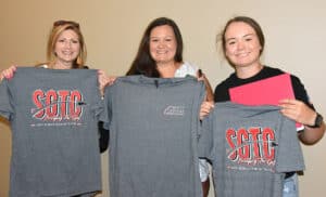 Shown above are some of the Caterpillar students and families displaying the free “Bridging the Gap t-shirts that they received at the orientation/registration day at SGTC.