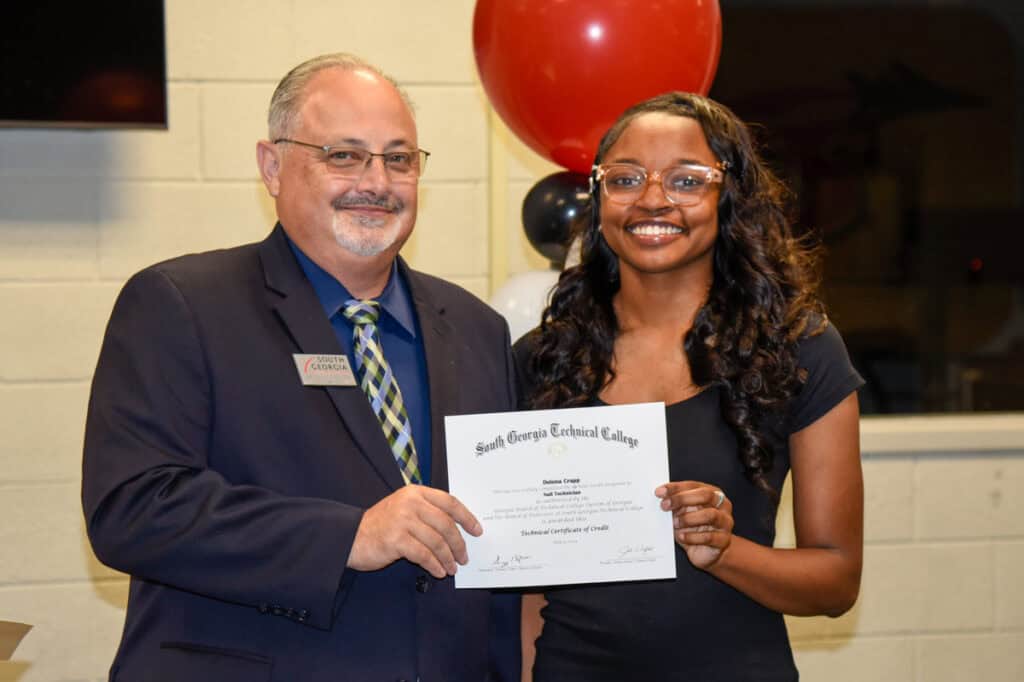 David Finley presents certificate to Deiona Crapp