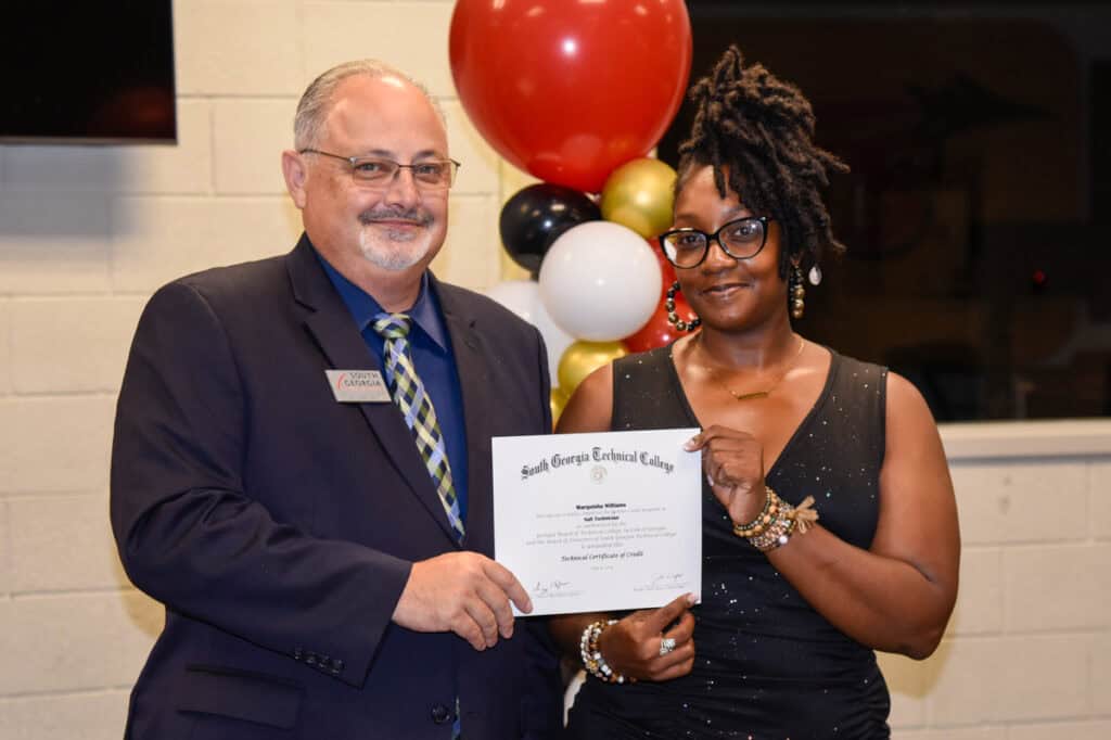 David Finley presents certificate to Marquisha Williams