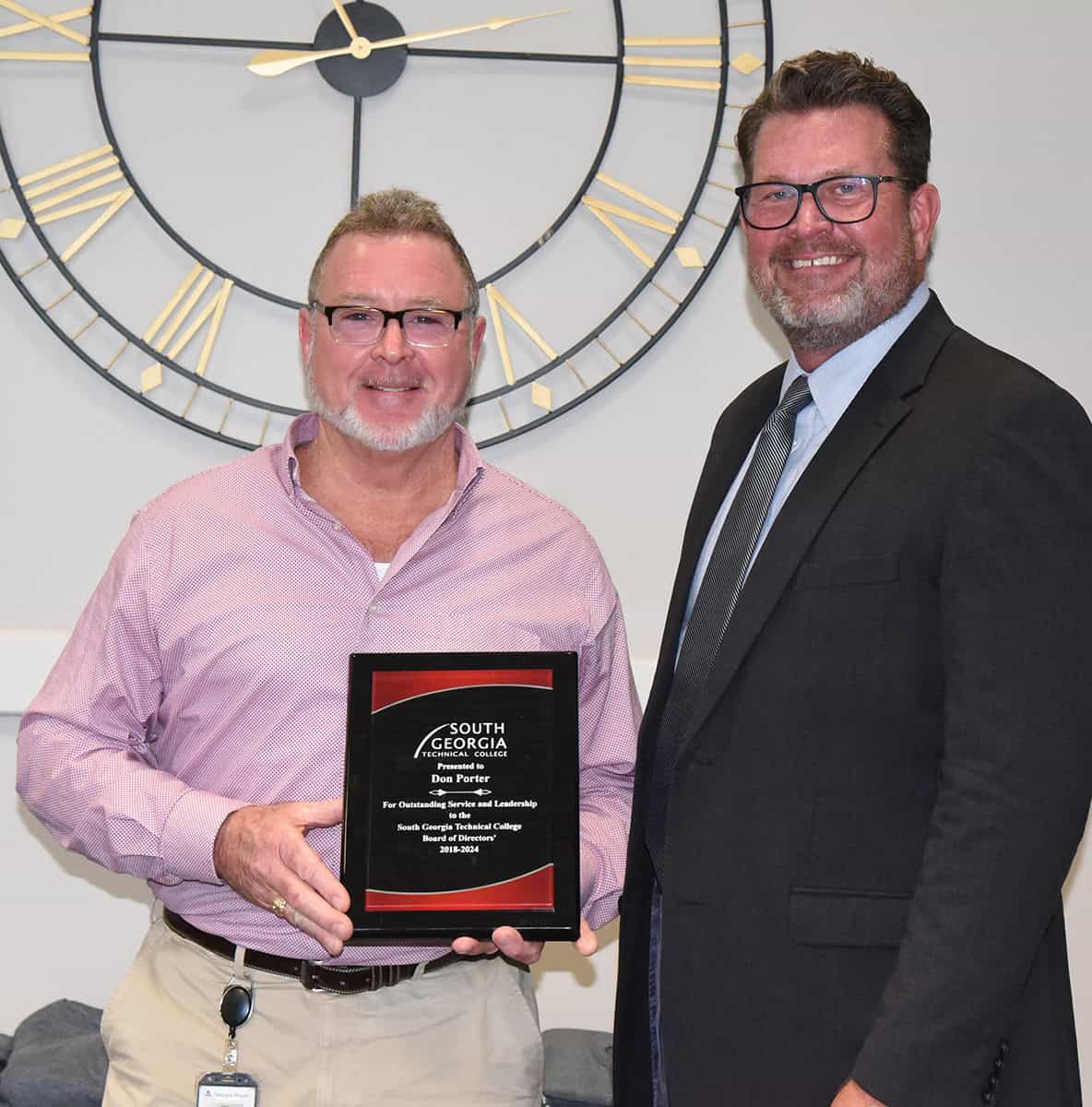 SGTC President Dr. John Watford (right) is shown above presenting the plaque to board member Don Porter of Georgia Power, who is relocating from Sumter County with Georgia Power.