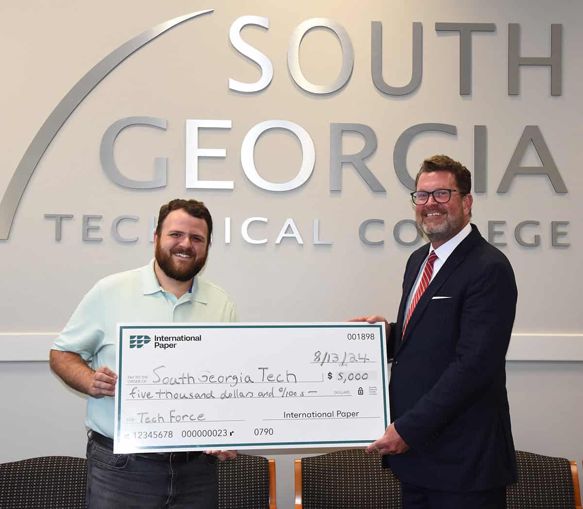 South Georgia Technical College President Dr. John Watford is shown above (right) receiving a grant donation from International Paper Flint River Mill from IP Flint River Mill Communications Coordinator Caleb Mims (shown left).