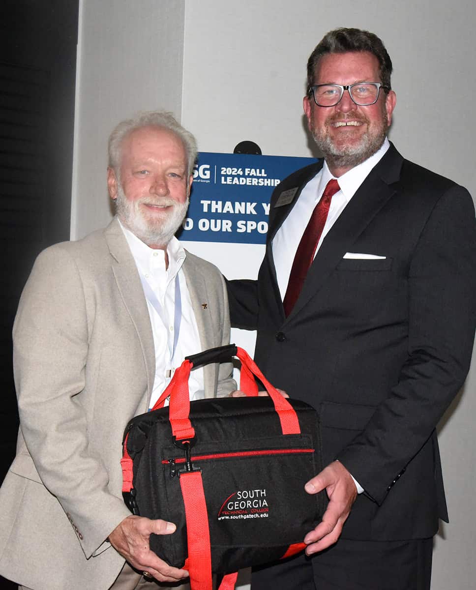 South Georgia Technical College President Dr. John Watford is shown above presenting a token of appreciation from the college to SGTC Alumni of the Year Dan Linginfelter for his outstanding achievements in the field of aviation maintenance.