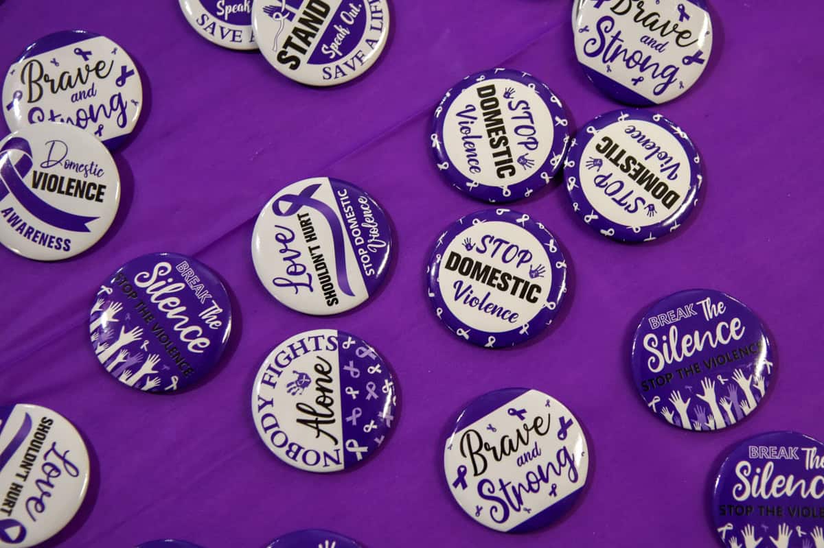 Promo buttons with slogans for domestic violence awareness