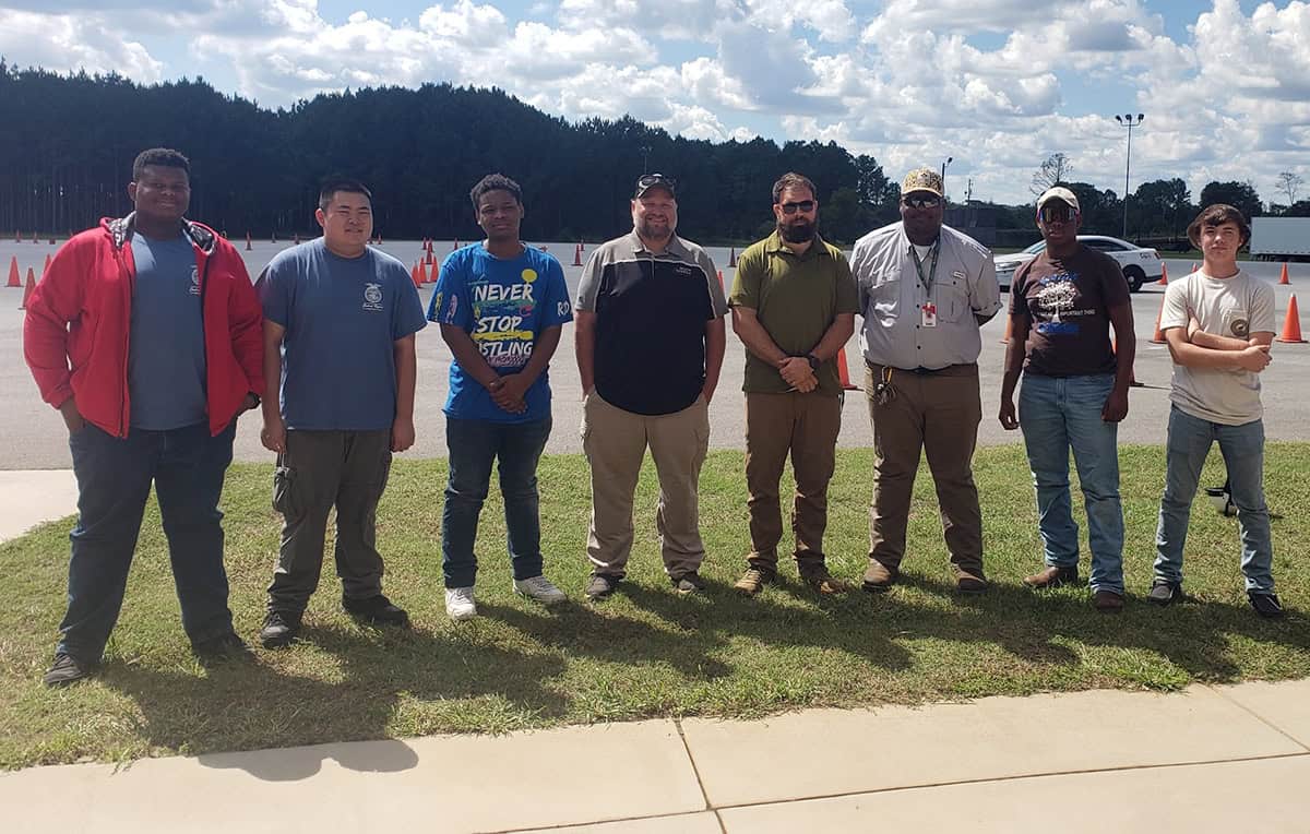 SGTC instructors Nick Edwards (center left) and Brandon Gross (center right) spoke recently with a group of Macon County high school students and Agriculture Educator Tommell Wilcox (third from right) during the group’s recent visit to the South Georgia Technical College campus in Americus.