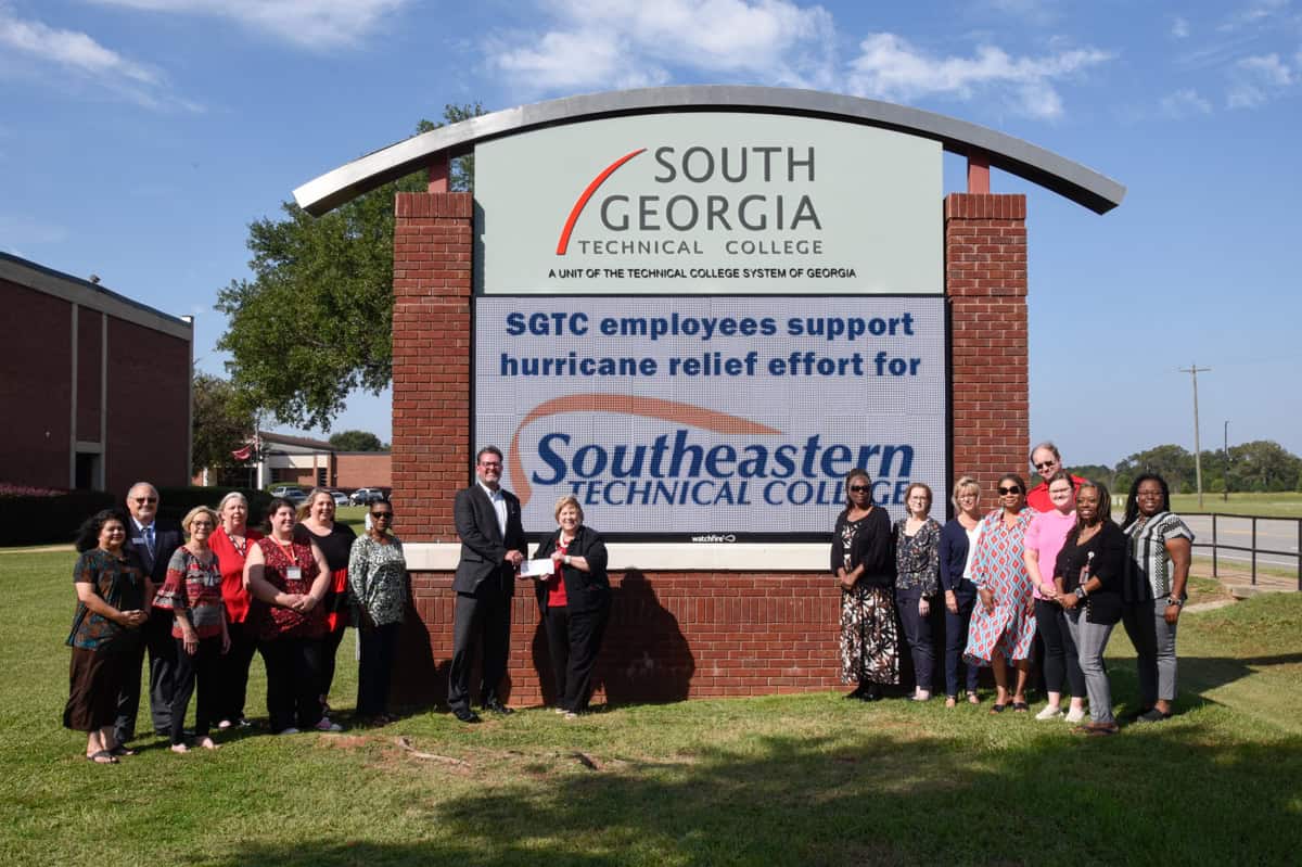 South Georgia Technical College President Dr. John Watford is shown above accepting a check from SGTC Foundation Executive Director Su Ann Bird from the funds donated to the South Georgia Technical College Foundation by SGTC faculty and staff for Hurricane Relief for the employees of Southeastern Technical College impacted by Hurricane Helene. Many of the South Georgia Tech employees who gave generously to their sister college employees are also shown.