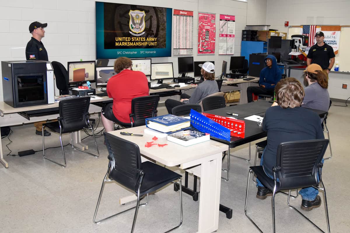 SGTC precision machining and welding students listen to a presentation from representatives of the United States Army Marksmanship Unit.