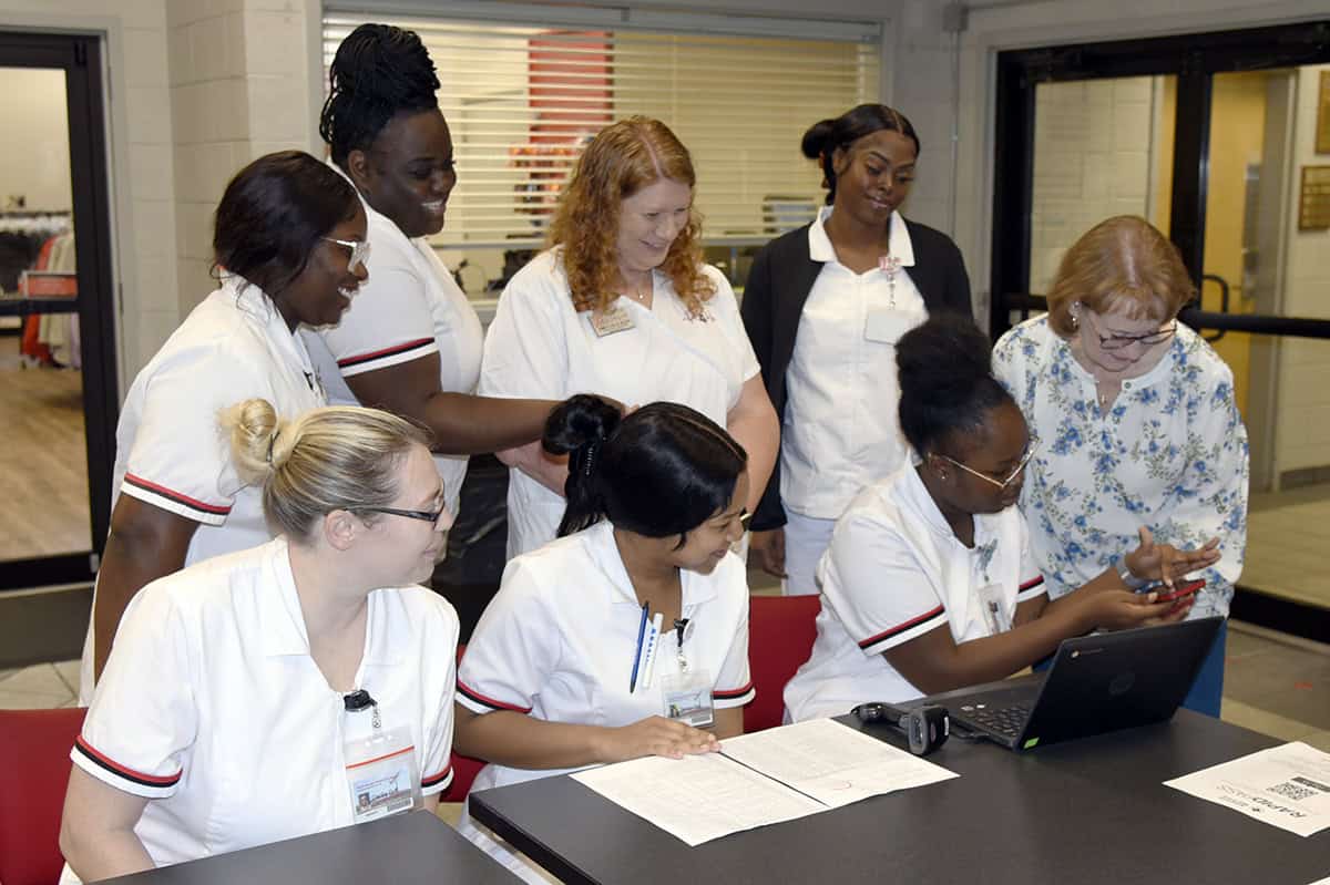 Practical Nursing instructor Jennifer Childs (standing, center) and students assist with donor check-in at the recent American Red Cross Blood Drive on the SGTC campus in Americus.