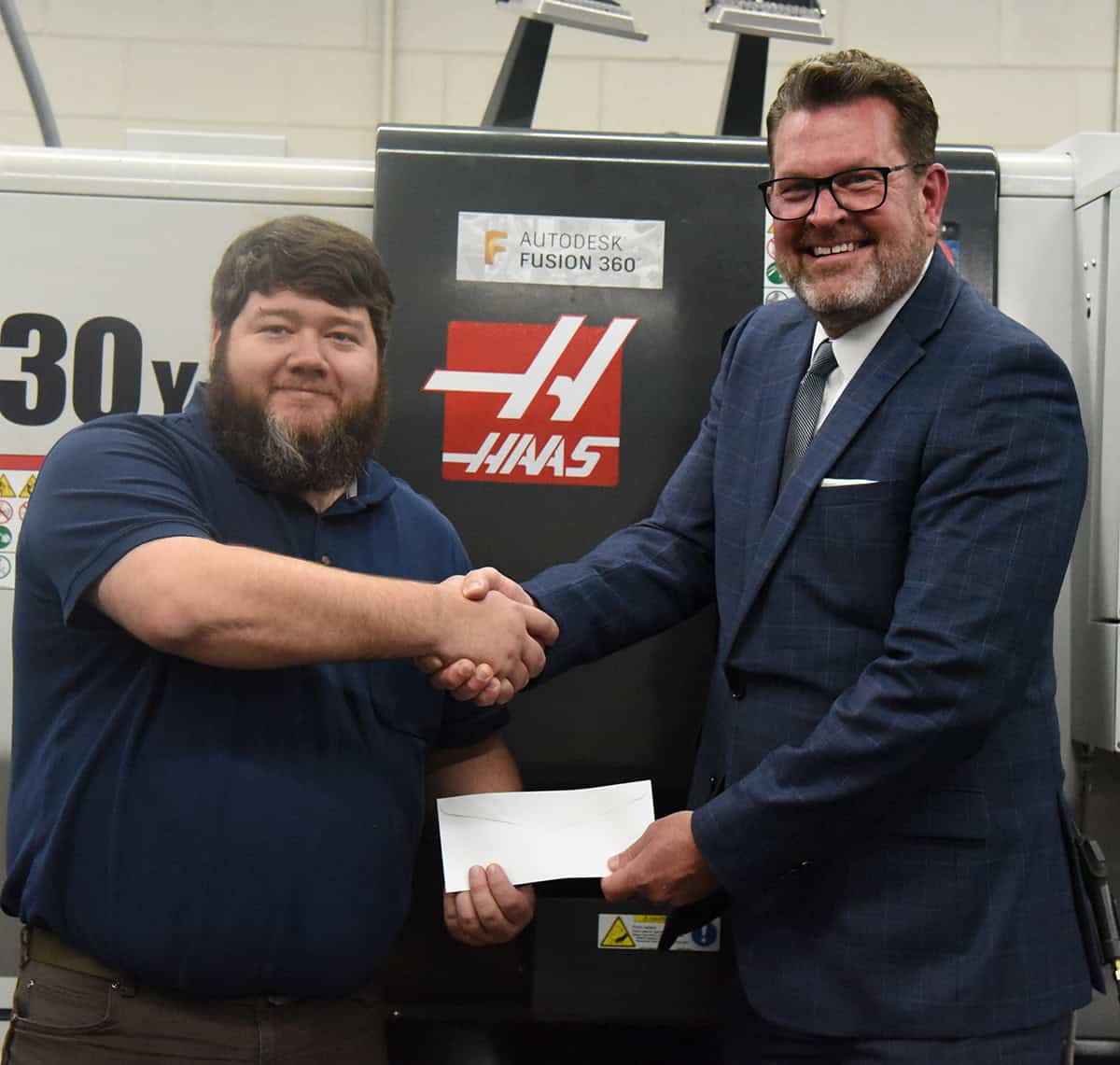 South Georgia Technical College President Dr. John Watford (right) is shown above with SGTC Precision Machining and Manufacturing Instructor Jake Pittman showing him the Gene Haas Foundation donation to the SGTC Foundation that will ultimately help his students and program.