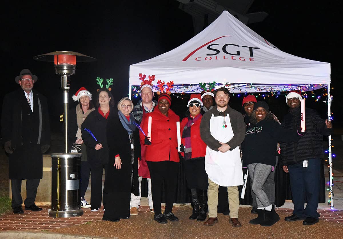 South Georgia Technical College President Dr. John Watford is shown above with members of the SGTC Student Affairs group that met each car with light up toys and goodies.