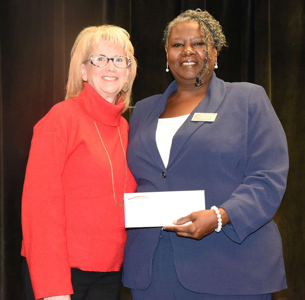 Synovus’ Tracy Hagerson (left) is shown above presenting Mary Cross with a donation from Synovus for being selected as the South Georgia Technical College 2025 Rick Perkins Instructor of the Year.