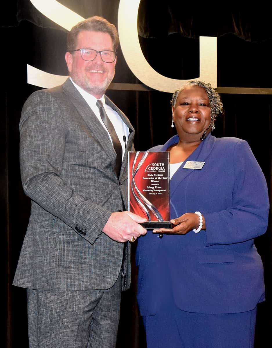 SGTC President Dr. John Watford (left) presents the Rick Perkins Instructor of the Year Award to marketing management instructor Mary Cross.