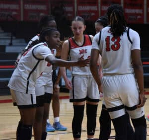 The Lady Jets huddle up before a free throw attemp.