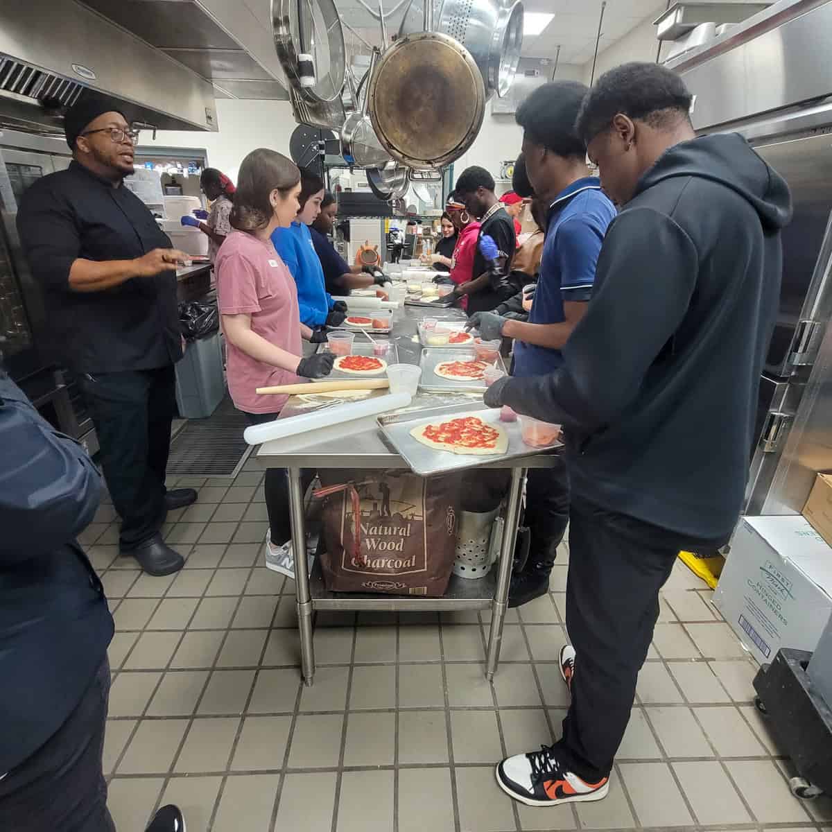 SGTC culinary arts instructor Johnny Davis (left) guides students through an activity during a recent STEM event at the college’s Crisp County Center in Cordele.