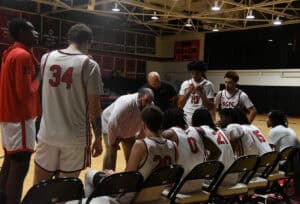 Coach Chris Ballauer and Coach Ray Johnson go over game strategy during the overtime time out.