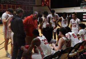 The Jets talk things over during a crucial timeout against Albany Tech.